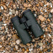 A top view of the Frontier APO 10x42 binoculars sitting on rocks