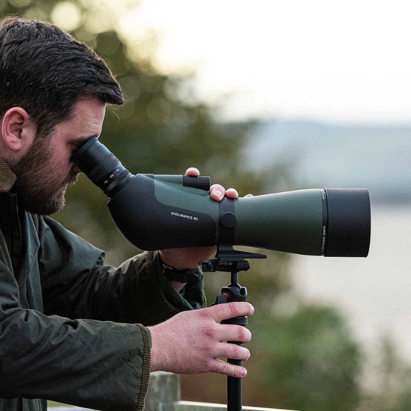 The Hawke Endurance ED 25-75x85 Green Spotting Scope mounted and being viewed through the eye piece