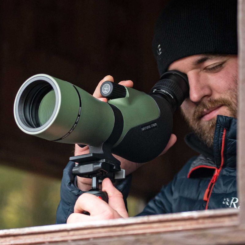 The Hawke NATURE-TREK 16-48X65 Spotting Scope in use by a bird watcher